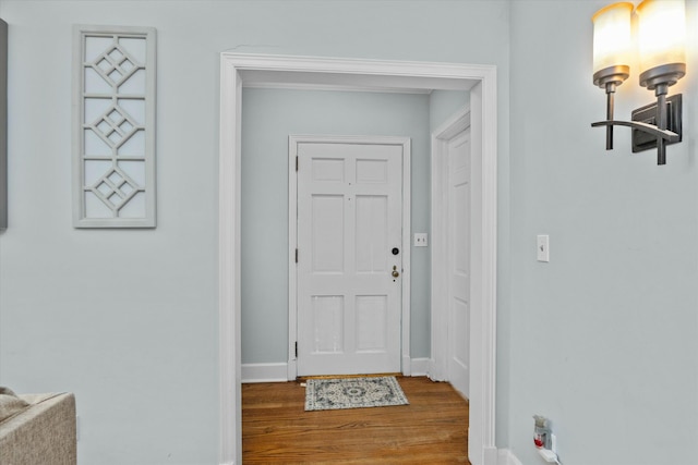 interior space featuring baseboards and wood finished floors