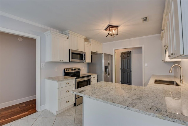 5776 Carriage Hills Dr, Martinez, GA 30907 - kitchen with appliances with stainless steel finishes, light stone countertops, white cabinetry, a peninsula, and crown molding