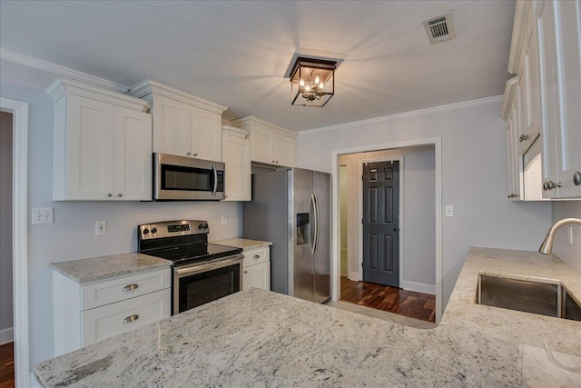 5776 Carriage Hills Dr, Martinez, GA 30907 - kitchen featuring appliances with stainless steel finishes, white cabinetry, light stone counters, crown molding, and dark wood-style flooring