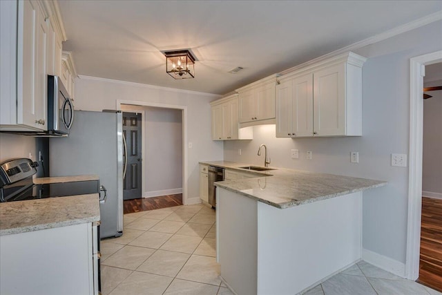 5776 Carriage Hills Dr, Martinez, GA 30907 - kitchen featuring appliances with stainless steel finishes, a peninsula, light stone countertops, ornamental molding, and white cabinets