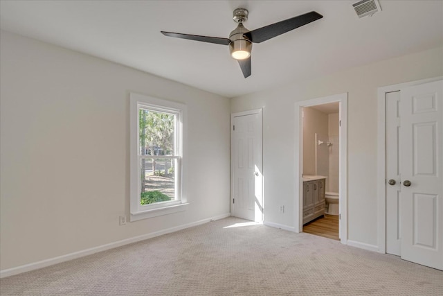 3408 Wheeler Rd, Augusta, GA 30909 - unfurnished bedroom with light colored carpet, baseboards, ensuite bathroom, and ceiling fan