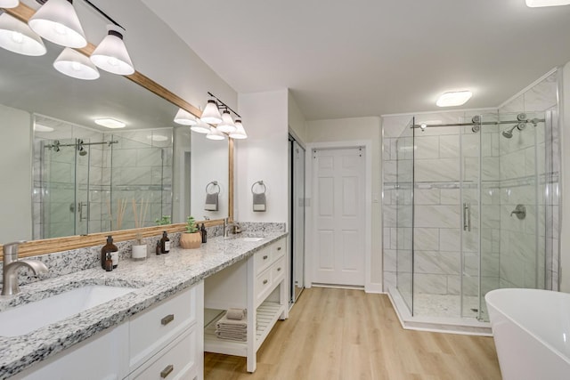 3408 Wheeler Rd, Augusta, GA 30909 - full bathroom featuring double vanity, wood finished floors, a stall shower, and a freestanding tub