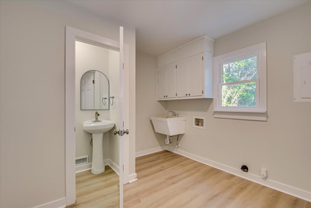 3408 Wheeler Rd, Augusta, GA 30909 - washroom featuring cabinet space, light wood finished floors, baseboards, hookup for a washing machine, and electric panel