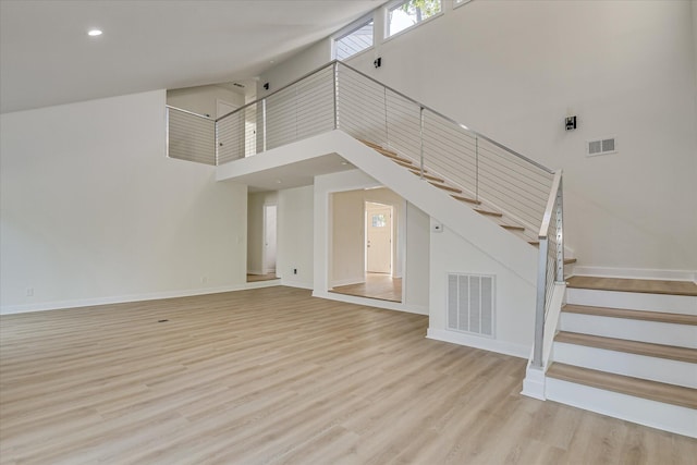 3408 Wheeler Rd, Augusta, GA 30909 - unfurnished living room with a high ceiling, stairs, wood finished floors, baseboards, and recessed lighting