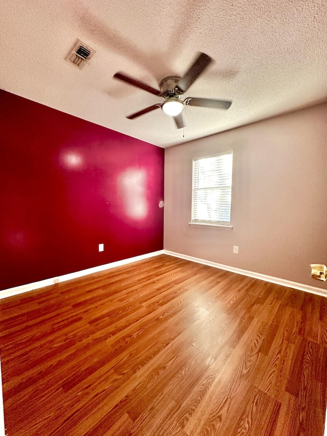 hall with a textured ceiling and light hardwood / wood-style floors