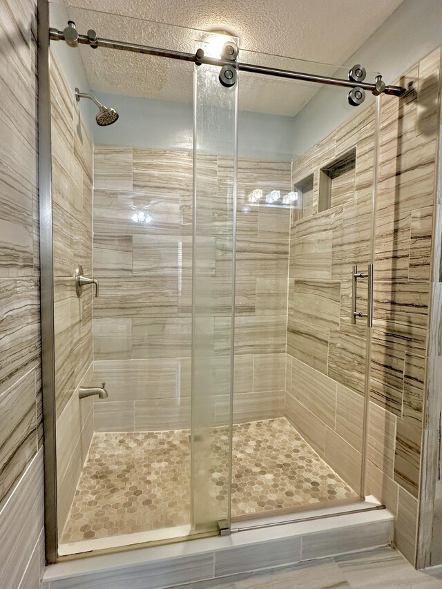 spare room featuring ceiling fan, a textured ceiling, and light hardwood / wood-style flooring