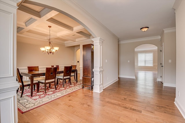 514 Hardwick Ct, Evans, GA 30809 - dining area featuring arched walkways, light wood-style floors, crown molding, beam ceiling, and baseboards