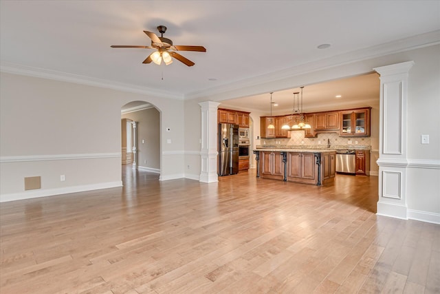 514 Hardwick Ct, Evans, GA 30809 - unfurnished living room with ceiling fan, light wood-style floors, baseboards, arched walkways, and ornamental molding