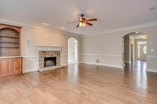 514 Hardwick Ct, Evans, GA 30809 - unfurnished living room with a ceiling fan, arched walkways, light wood-style floors, and ornamental molding