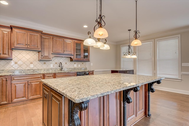 514 Hardwick Ct, Evans, GA 30809 - kitchen featuring a kitchen breakfast bar, light stone countertops, crown molding, a center island, and recessed lighting