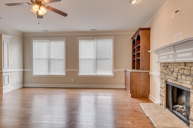514 Hardwick Ct, Evans, GA 30809 - unfurnished living room with a ceiling fan, a stone fireplace, crown molding, light wood finished floors, and baseboards