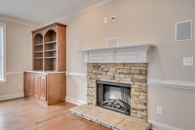 514 Hardwick Ct, Evans, GA 30809 - unfurnished living room with light wood-type flooring, a stone fireplace, baseboards, and crown molding