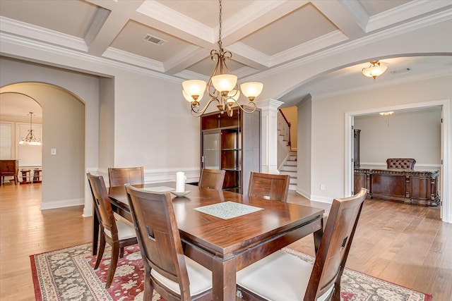 514 Hardwick Ct, Evans, GA 30809 - dining space with arched walkways, a chandelier, light wood-style flooring, beam ceiling, and ornamental molding