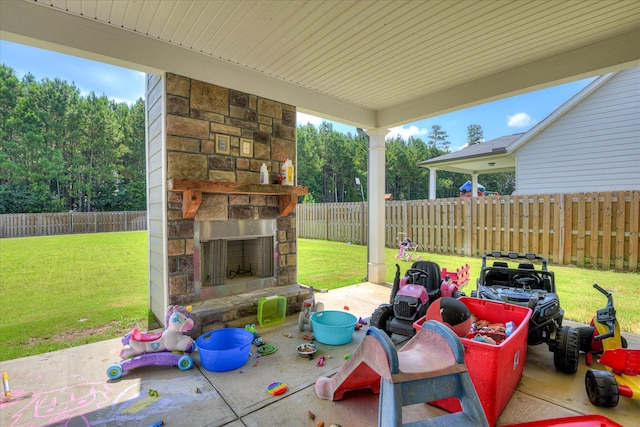 3015 Bannack Ln, Harlem, GA 30814 - fenced backyard featuring an outdoor stone fireplace and a patio area