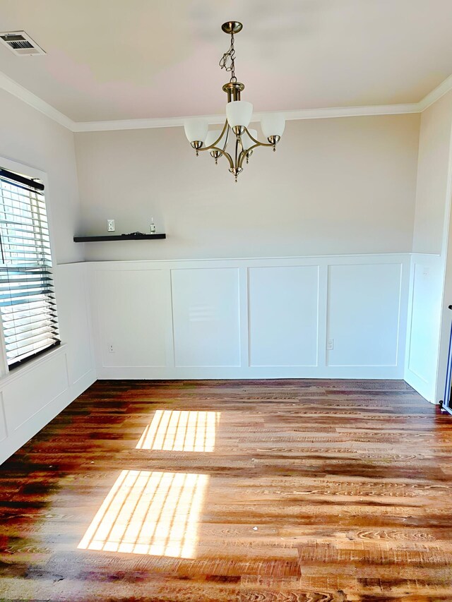 3015 Bannack Ln, Harlem, GA 30814 - unfurnished dining area featuring a decorative wall, ornamental molding, a chandelier, a wainscoted wall, and wood finished floors