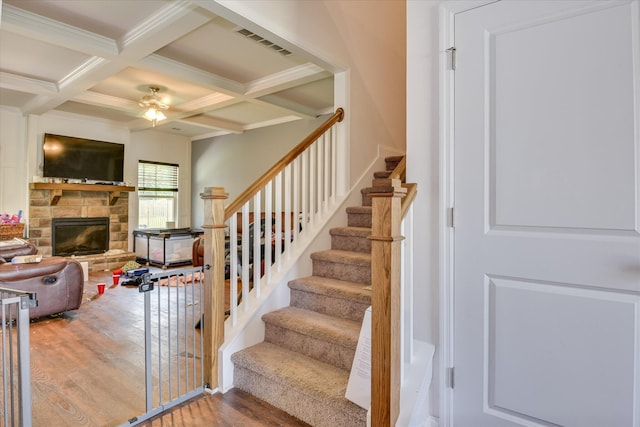 3015 Bannack Ln, Harlem, GA 30814 - stairs with wood finished floors, beam ceiling, a fireplace, coffered ceiling, and a ceiling fan