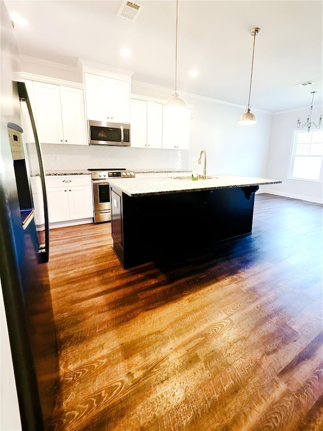 3015 Bannack Ln, Harlem, GA 30814 - kitchen with stainless steel appliances, ornamental molding, wood finished floors, a kitchen island with sink, and pendant lighting