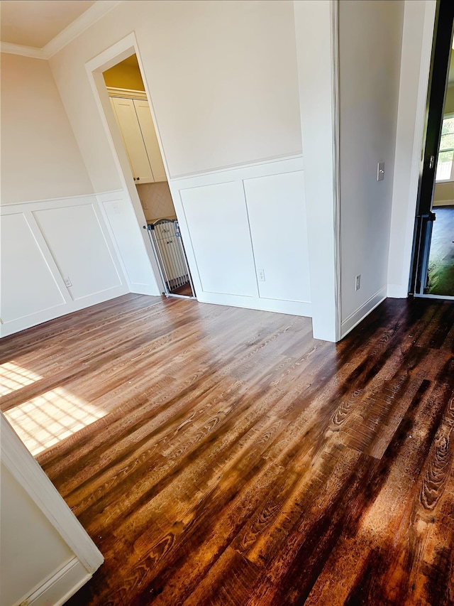 3015 Bannack Ln, Harlem, GA 30814 - unfurnished bedroom featuring a decorative wall, crown molding, dark wood-type flooring, and a wainscoted wall
