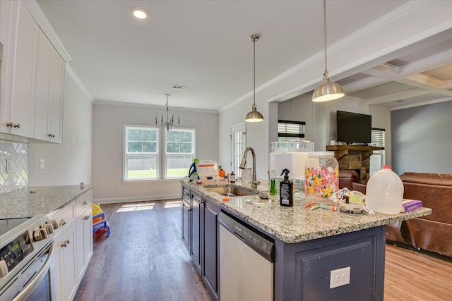 3015 Bannack Ln, Harlem, GA 30814 - kitchen with stainless steel appliances, open floor plan, white cabinetry, wood finished floors, and ornamental molding