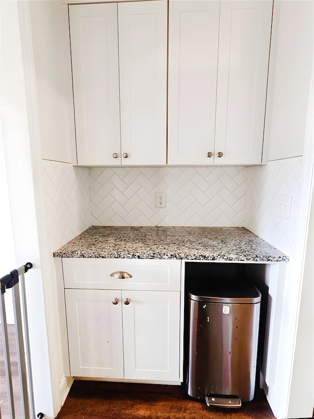 3015 Bannack Ln, Harlem, GA 30814 - kitchen featuring light stone counters, decorative backsplash, and white cabinets