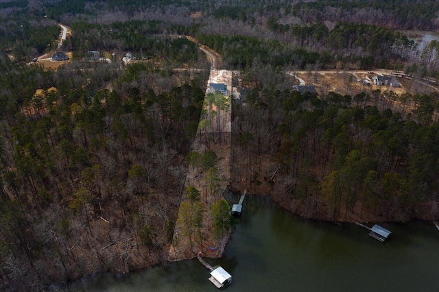 aerial view with a water view and a forest view