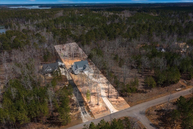 birds eye view of property with a view of trees