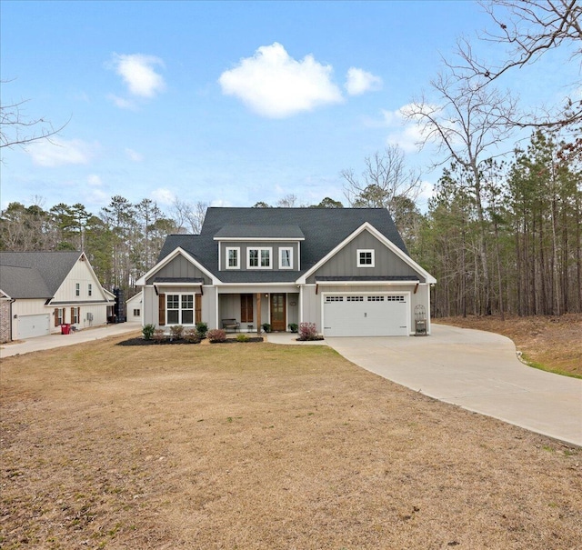 view of front of home with board and batten siding, driveway, and a front lawn