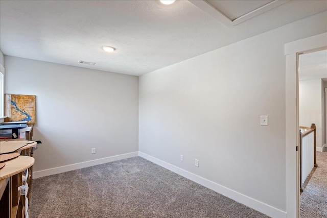 unfurnished room with light colored carpet, visible vents, and baseboards