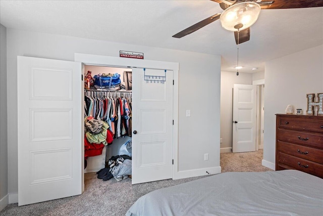 carpeted bedroom featuring a closet, ceiling fan, and baseboards