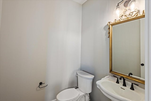 bathroom featuring toilet and a sink