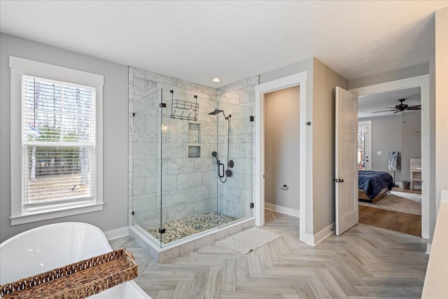 full bathroom with a freestanding tub, baseboards, ensuite bathroom, and a stall shower