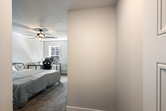 bedroom with carpet floors, ceiling fan, and a textured ceiling