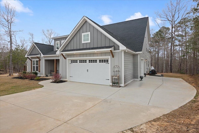 view of front of home featuring a garage, driveway, a shingled roof, and board and batten siding