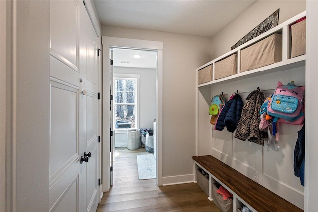 mudroom with dark wood-type flooring and baseboards