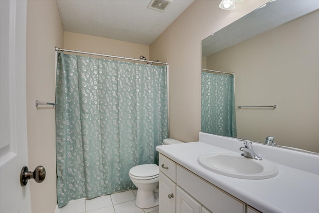 bathroom with tile patterned floors, vanity, toilet, and a textured ceiling