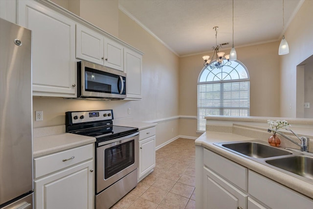 kitchen with appliances with stainless steel finishes, crown molding, decorative light fixtures, white cabinets, and a chandelier