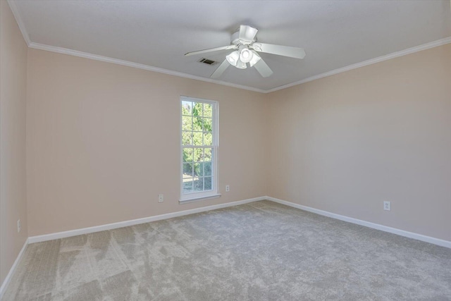 carpeted spare room featuring ceiling fan and crown molding