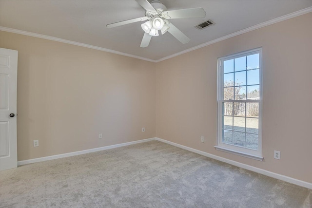 carpeted empty room featuring ceiling fan and ornamental molding