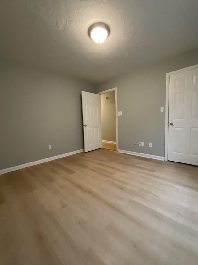 1129 Waltons Trl, Hephzibah, GA 30815 - unfurnished bedroom with baseboards and wood finished floors