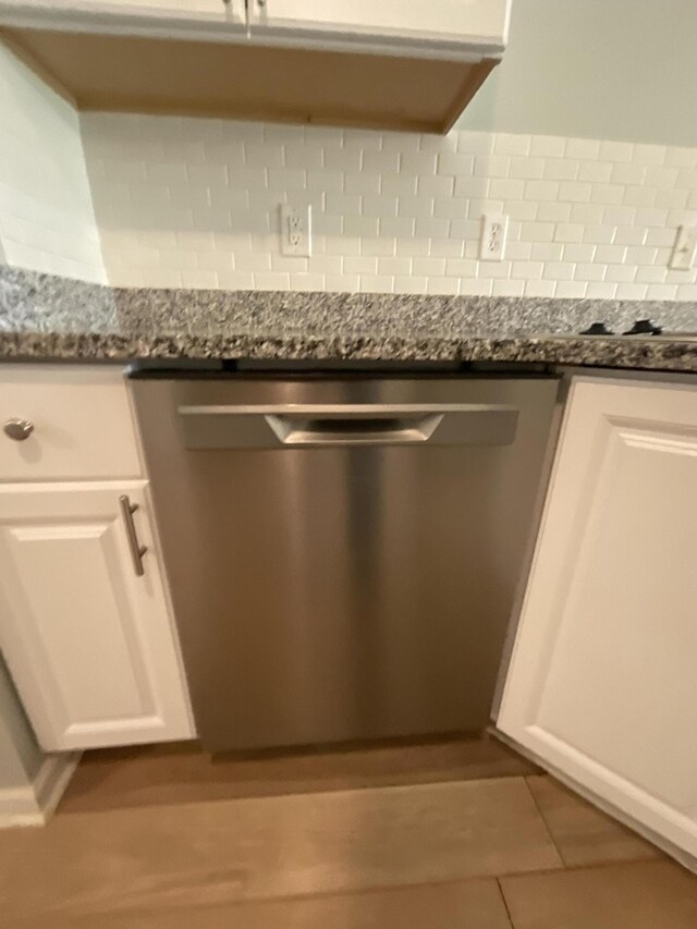 1129 Waltons Trl, Hephzibah, GA 30815 - detailed view of dishwasher, tasteful backsplash, white cabinets, and dark stone countertops