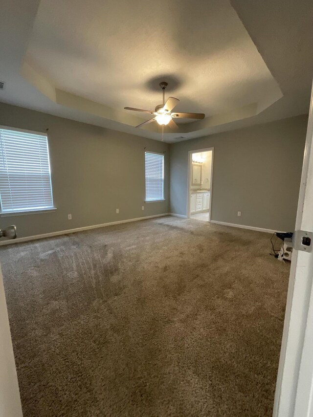 1129 Waltons Trl, Hephzibah, GA 30815 - unfurnished room with a raised ceiling, baseboards, a ceiling fan, and carpet floors