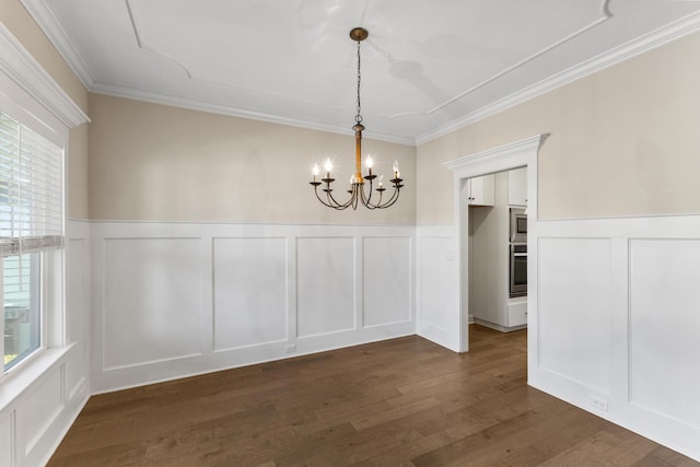 unfurnished dining area with crown molding, plenty of natural light, dark wood-type flooring, and an inviting chandelier