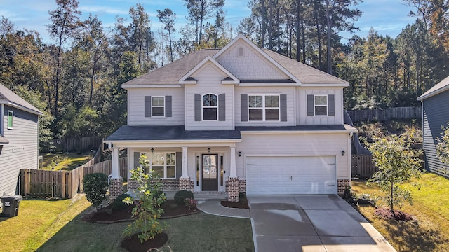 craftsman house with covered porch, a garage, and a front lawn