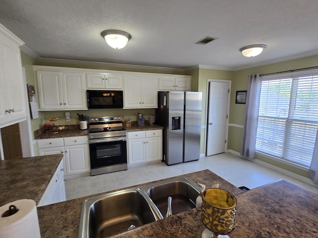 318 Elbrus Way, Grovetown, GA 30813 - kitchen with dark countertops, stainless steel appliances, white cabinetry, and crown molding