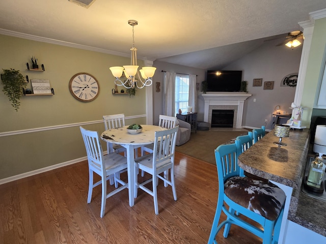 318 Elbrus Way, Grovetown, GA 30813 - dining room featuring wood finished floors, a tiled fireplace, a chandelier, lofted ceiling, and a ceiling fan