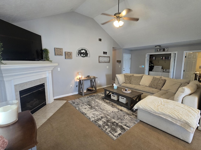 318 Elbrus Way, Grovetown, GA 30813 - tiled living room with washer and clothes dryer, a ceiling fan, high vaulted ceiling, and a tiled fireplace