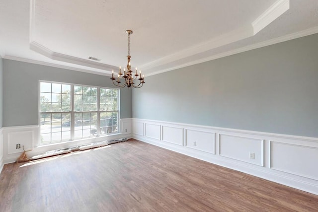 5209 Windmill Ct, Evans, GA 30809 - empty room featuring a tray ceiling, a chandelier, ornamental molding, a wainscoted wall, and wood finished floors