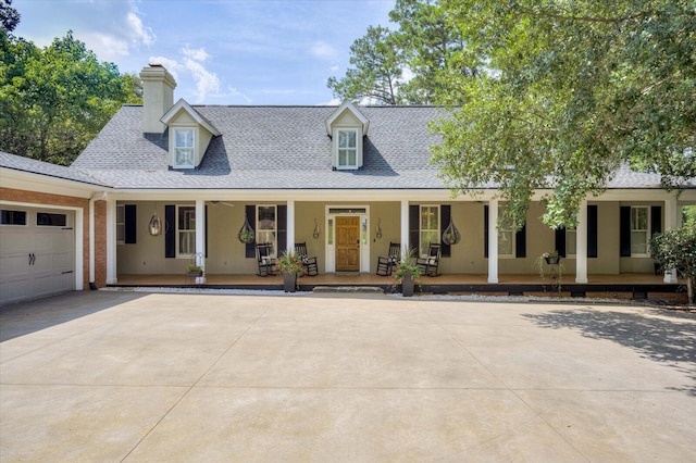 new england style home with a porch and a garage