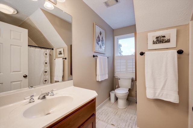 bathroom featuring a textured ceiling, vanity, tile patterned flooring, toilet, and curtained shower