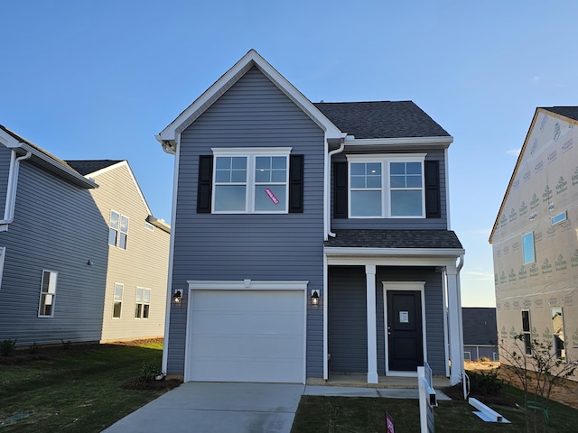 view of front property with a porch, a garage, and a front lawn